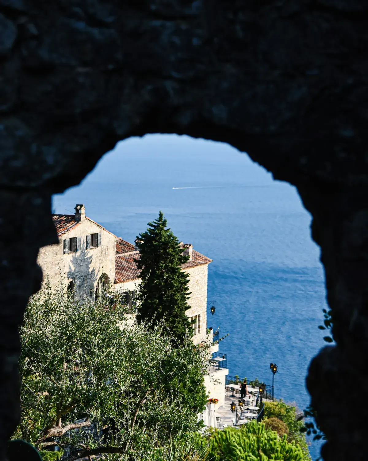 Mediterranean villa framed by a stone arch
